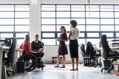 Disability inclusion in the workplace with people in wheelchairs.